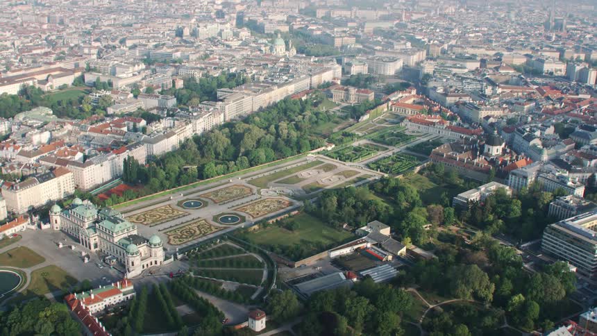 A building with a large courtyard containing gardens in a city