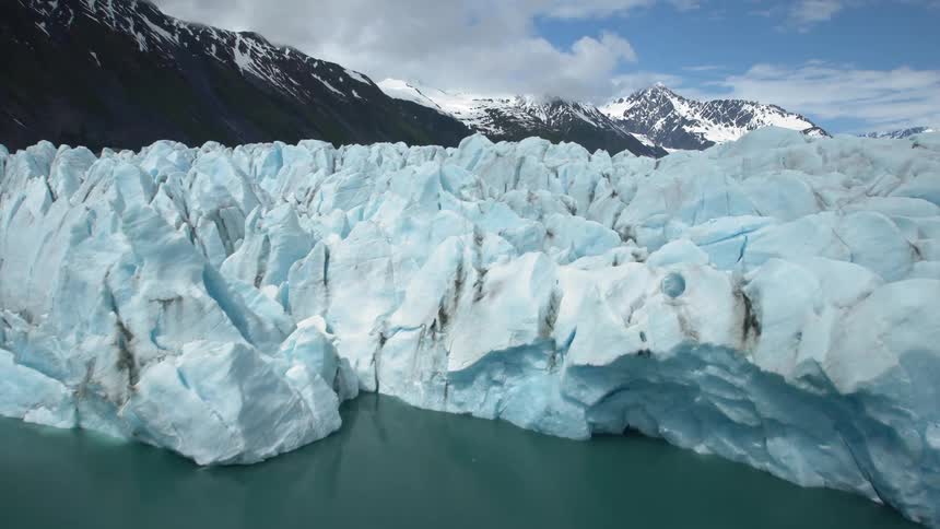 Glacier in front of snow covered mountain range