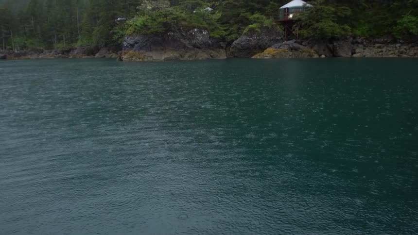 A building on the shore on a rainy day