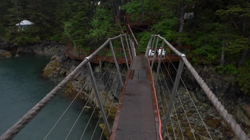 High pedestrian suspension bridge over inlet