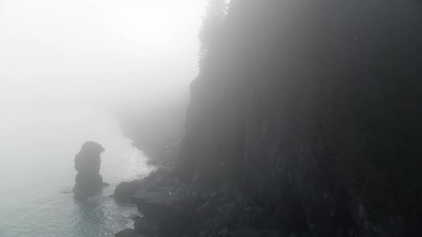 Fog covered seaside cliff and coastline