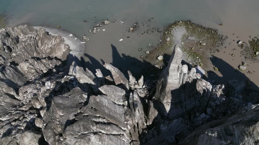 Cracks form on a cliff that sits on a beach