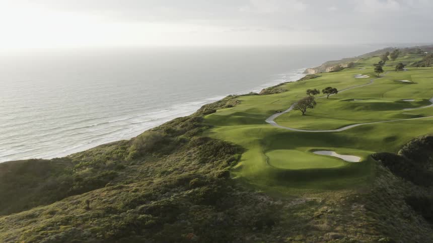 A golf course sits on a cliff that overlooks the ocean