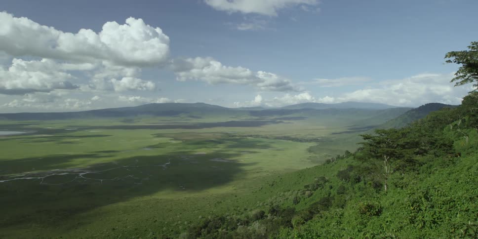 Clouds float over a green valley