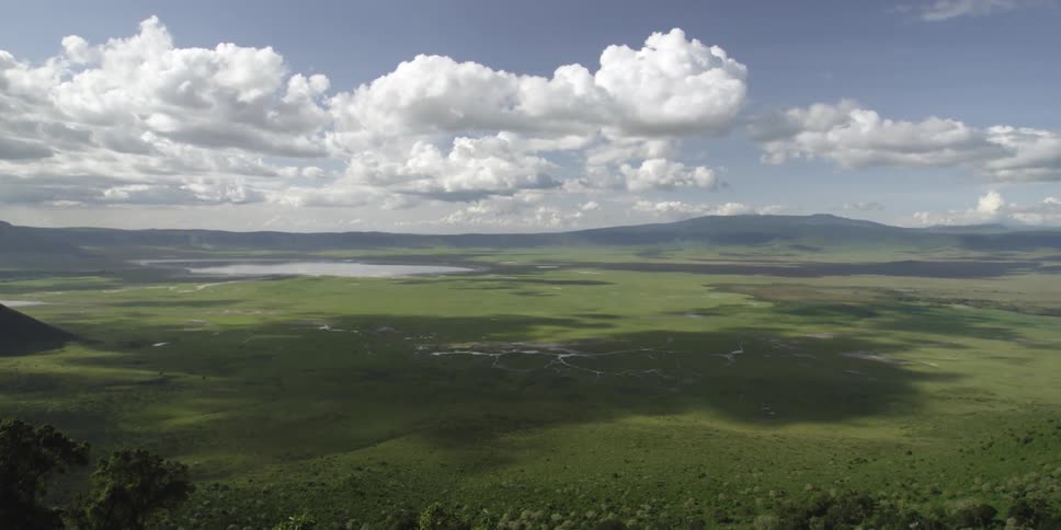 Clouds float over a green valley