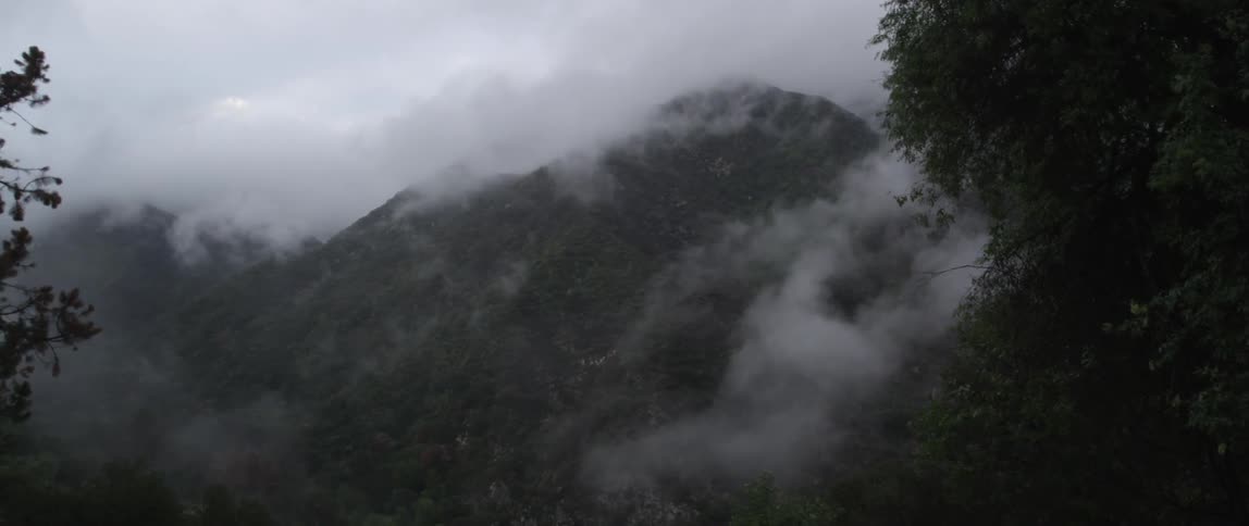 Clouds and fog cover these hills