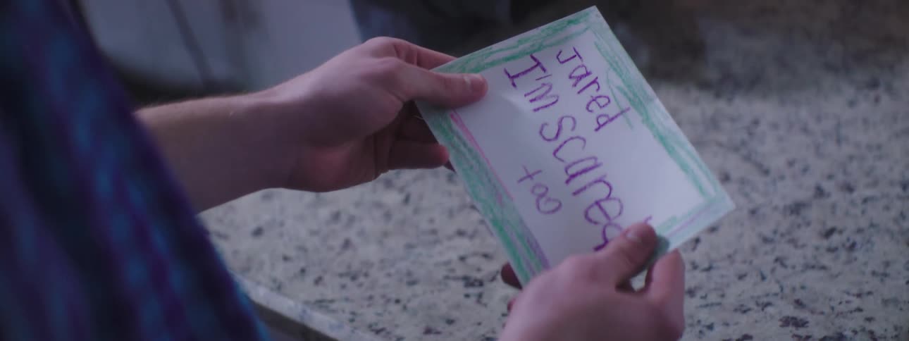 A note is handed to a man