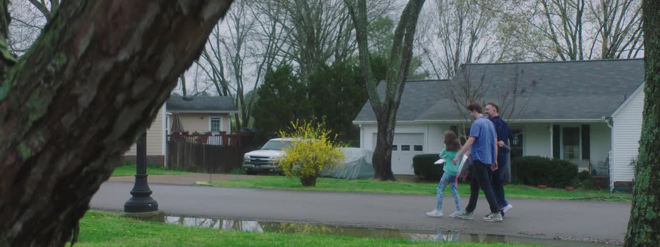 Family walks down the street in the neighborhood