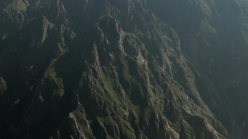 View of some very tall mountains covered in green grass