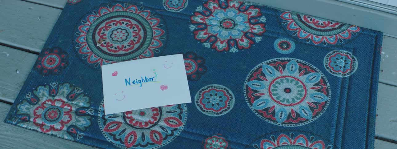 A letter being dropped on a door mat