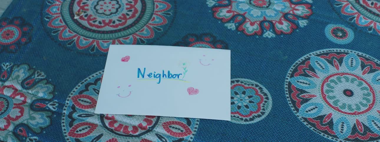 Piece of paper with hearts and printing on it falls onto a carpet