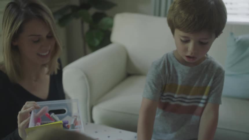 Children writes and the paints paper using crayon