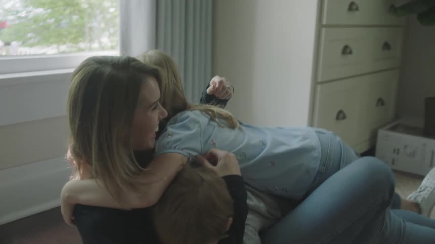Mother and children having fun in the living room