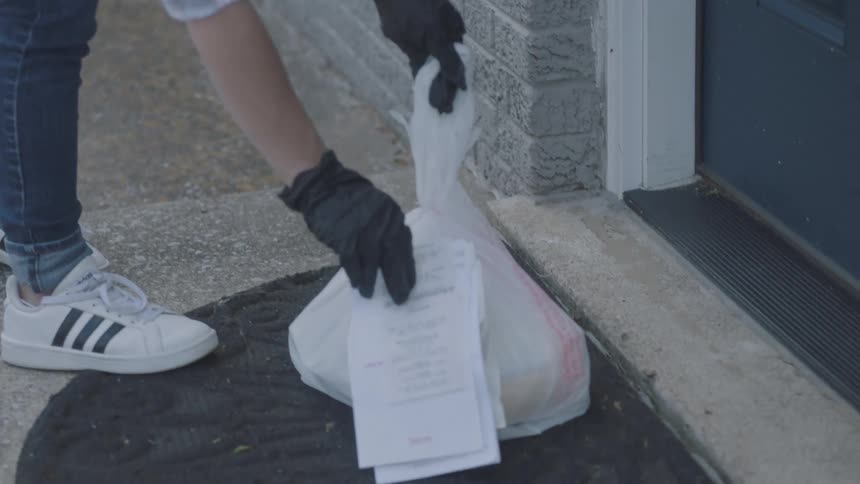 A teenager working for a delivery service puts items on a porch and knocks on the door