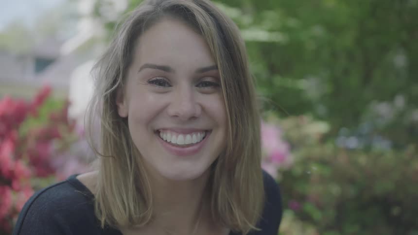 Blonde woman looks at camera and smile