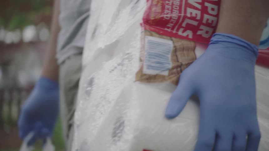 Man wearing gloves delivers groceries