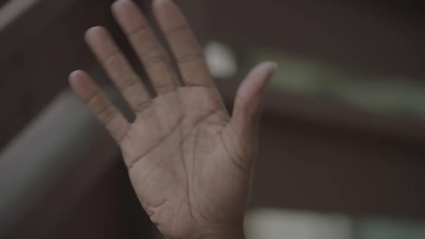 Black man waves at the white woman who delivers the food bags