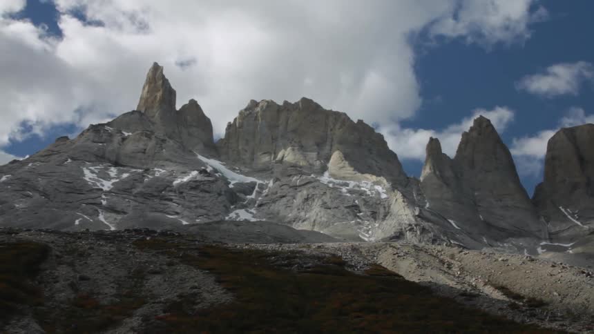 Clouds pass over large rock formations
