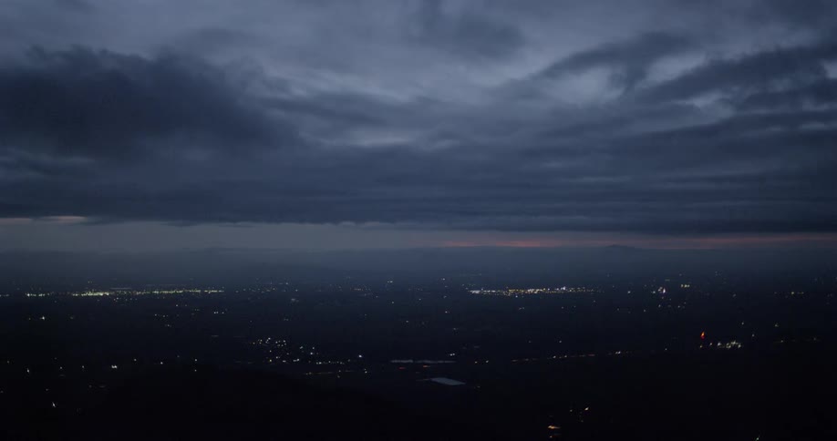 Dark clouds roll in over a town at night