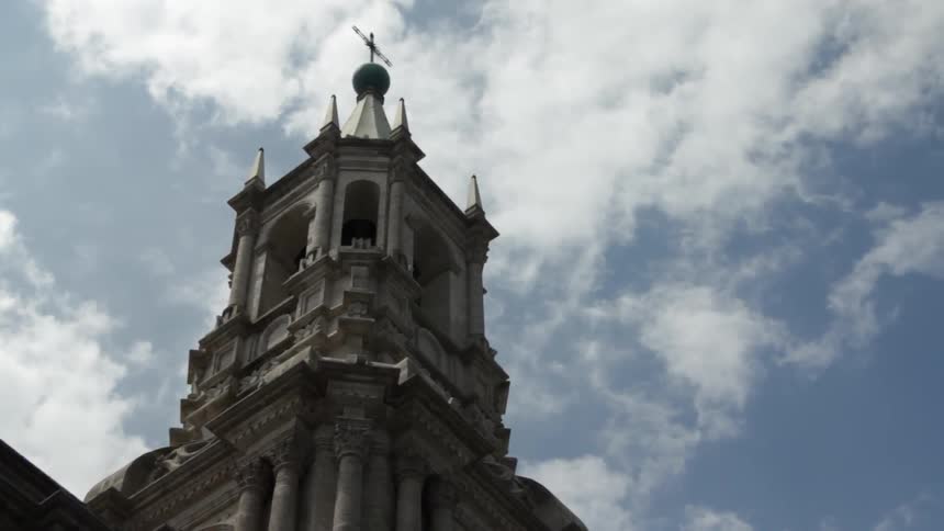 Clouds float over a building tower