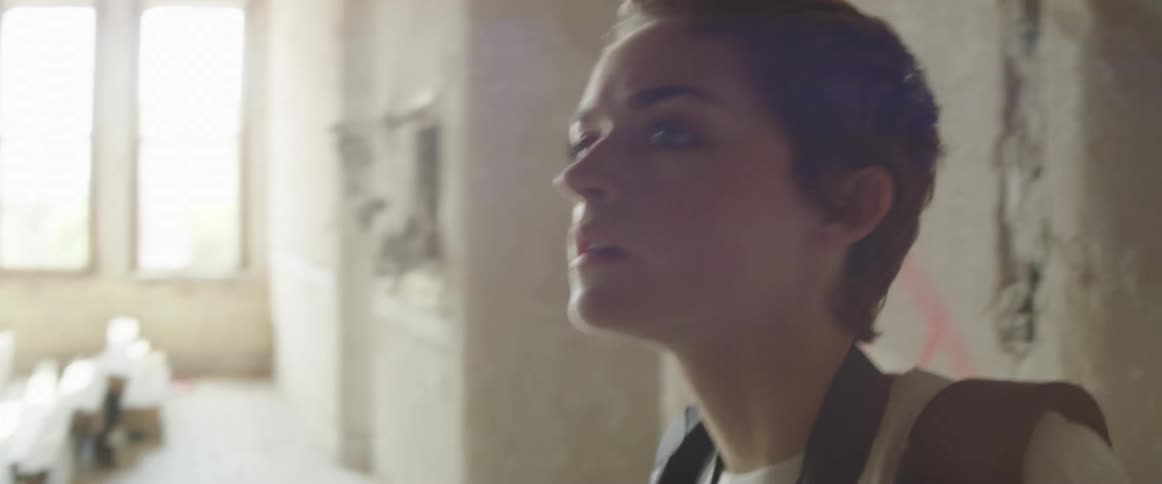A young woman explores an abandoned room