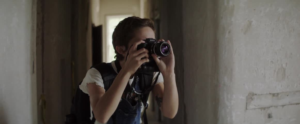 A woman takes a picture in the hall
