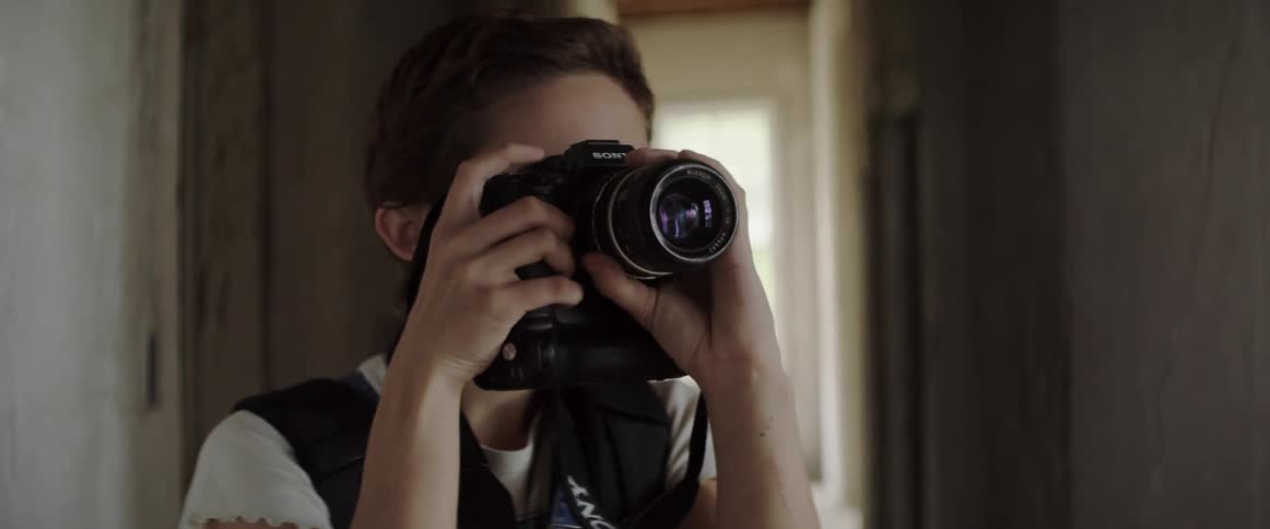 A woman with a backpack and a camera