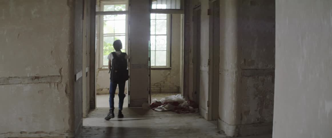 A girl is in a building and holding a camera