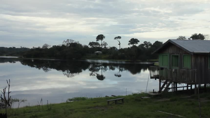 A building sits next to a calm lake