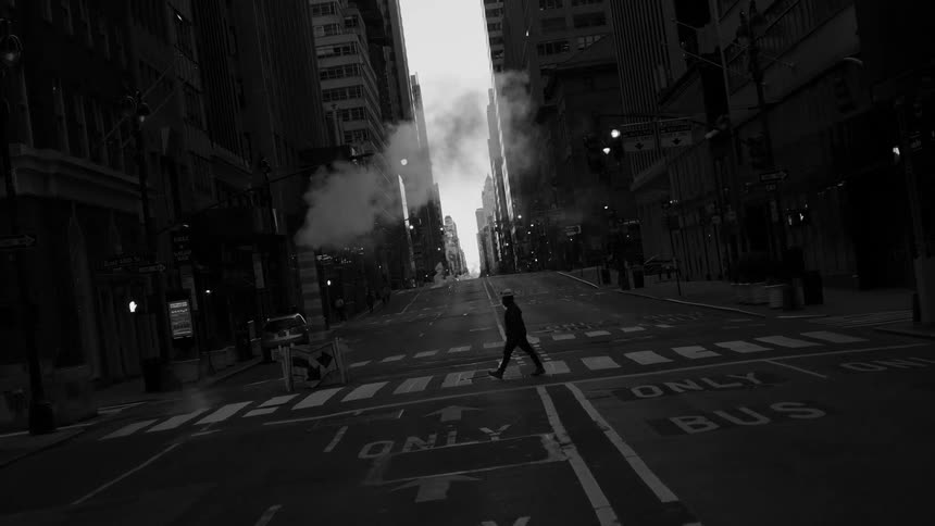 A person walks across the road