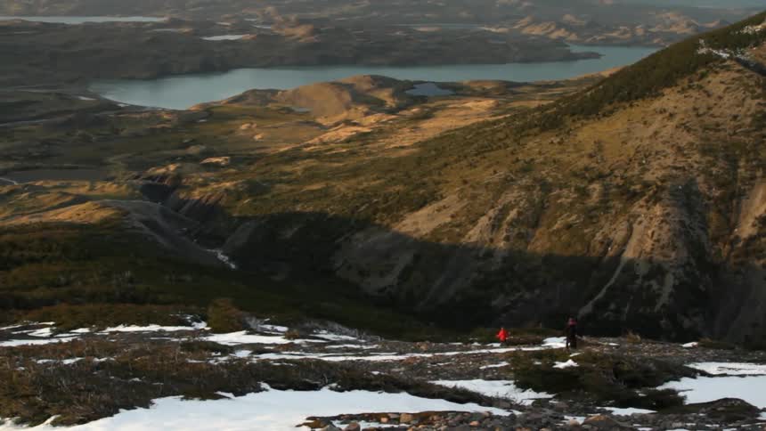 People walking on a mountainside trail