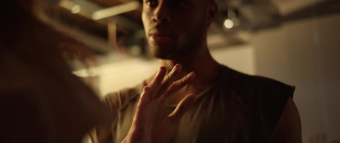 A man looks confused while inspecting his hand