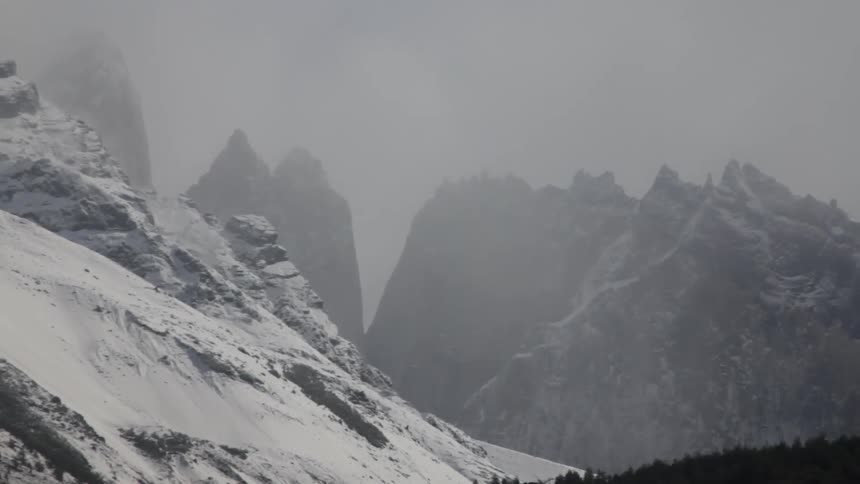 Snow covered mountainside on a cloudy day