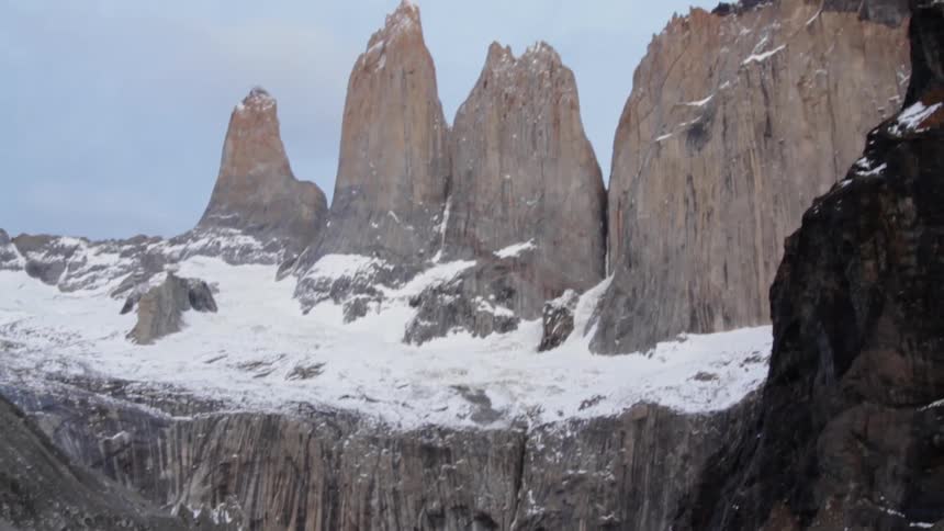 Tall rock formations surround a mountain lake