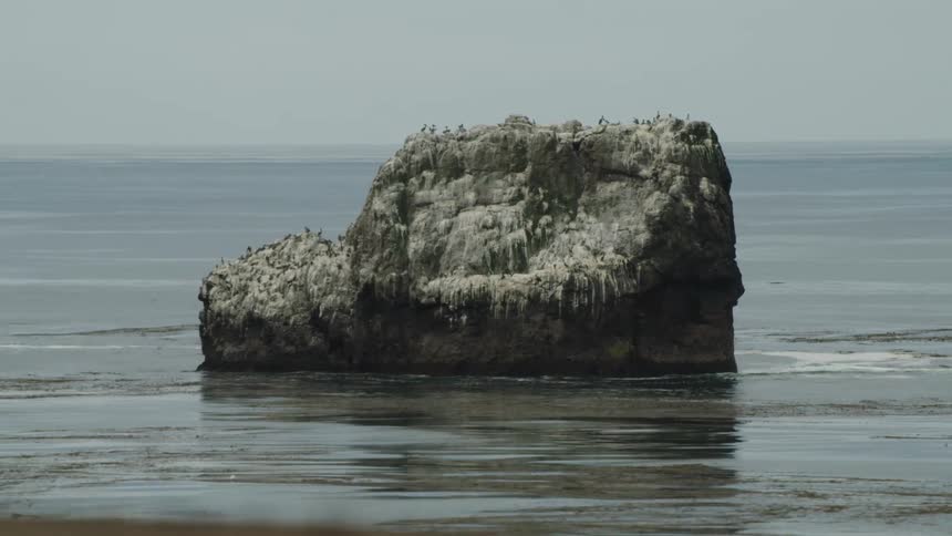 A small promontory sits in the ocean