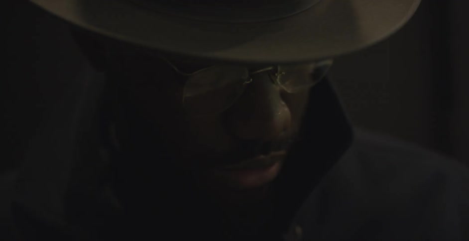 A young black man contemplatively thinking