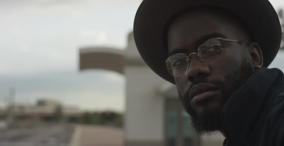 A black man looking off to the side