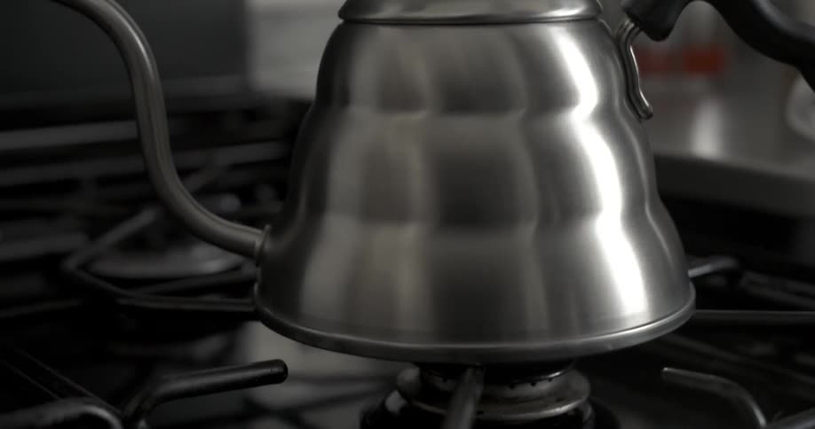 A kettle is placed in a gas burner