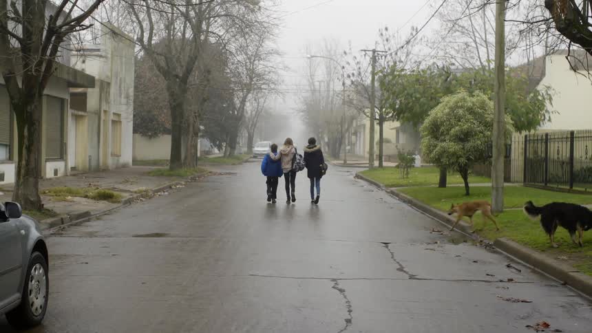 Three kids walk down the road