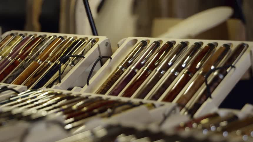 Display of ball point pens in a white tray in a store