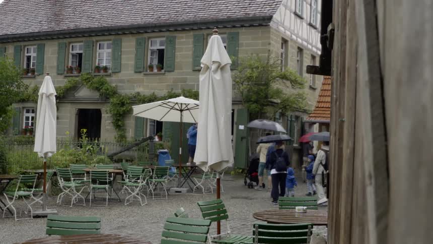 A family walks through a courtyard