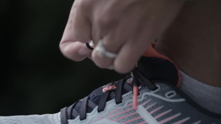 Woman ties shoe laces