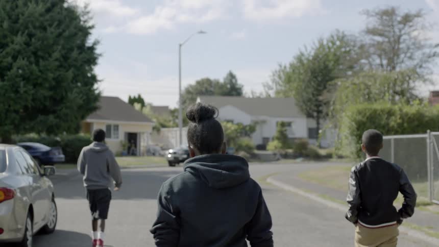 Kids walk along the road in the neighborhood