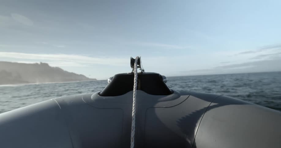 Inflatable raft floating in the ocean near coast at day