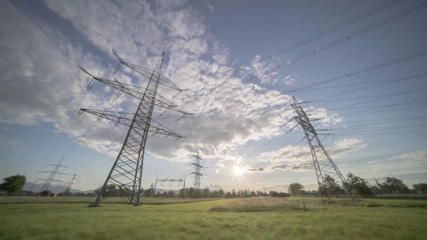 Transmission towers loom over the landscape