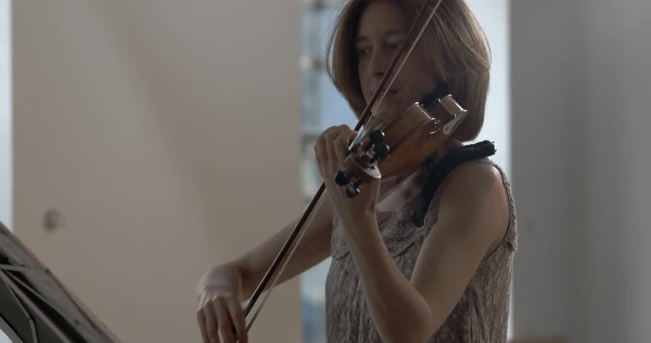A woman plays a violin