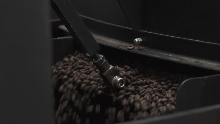 Coffee beans pour out of a machine