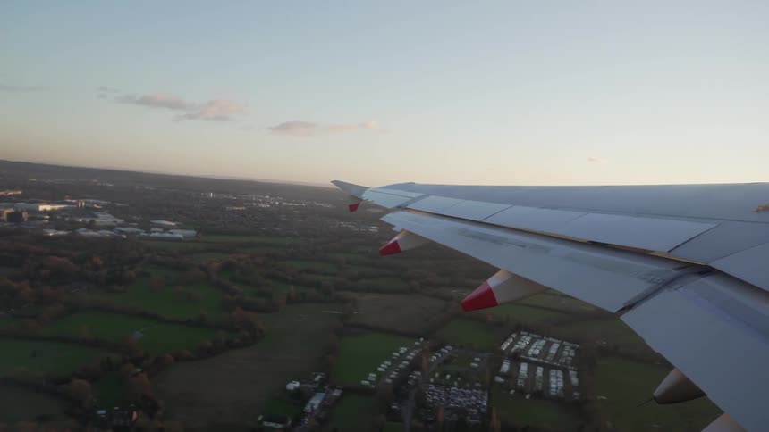 View of a airplane wing as the plane takes off from a runway