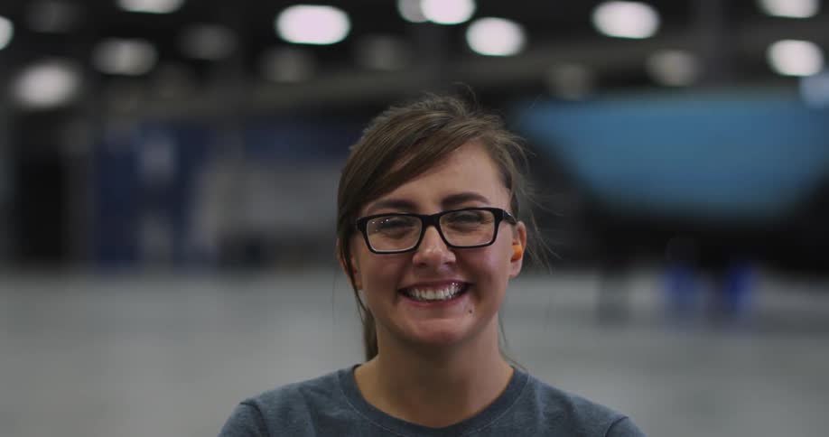 A woman wearing glasses smiles