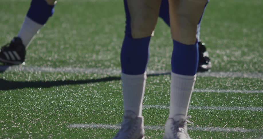 A player is stretching on a field